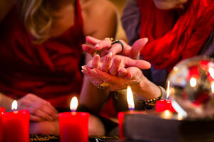 Photo of psychic reading palm, with candles